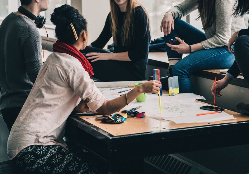 Students gathered around a table working on a group project